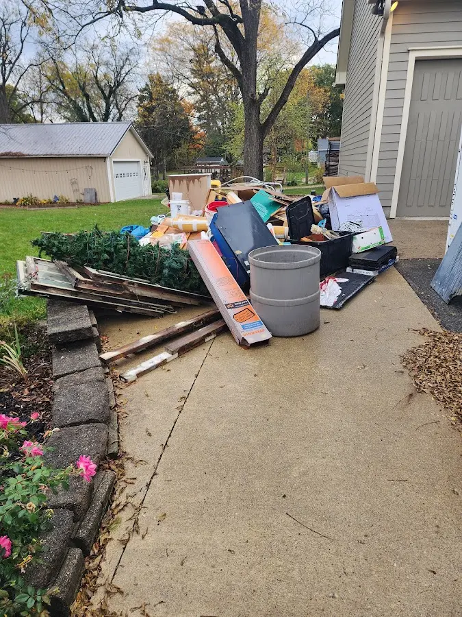 Dumpster being loaded with debris for Commercial Dumpster Rental in Mechanic Falls
